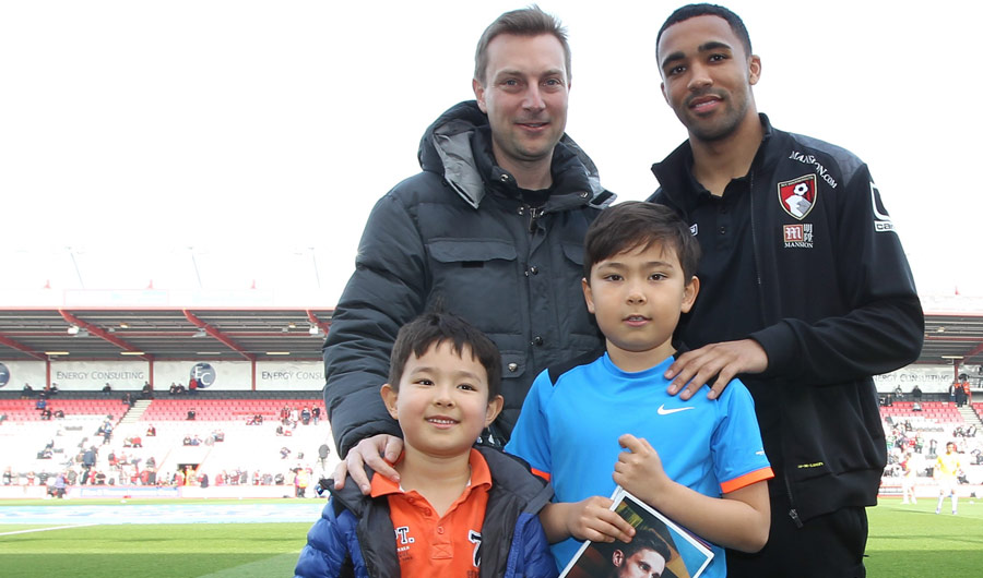 AFCB player Callum Wilson with poster competition winner Richard Kopfli (right) with Richard's dad and brother