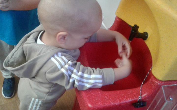 Children learning to wash hands at Honeypot Nursery