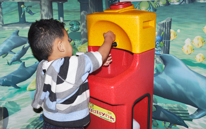 Child washing his hands in preschool with a Teal KiddiSynk