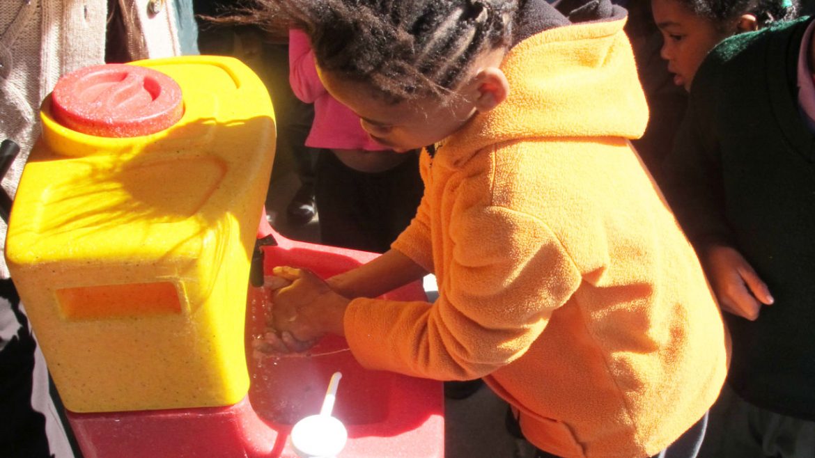 Children learning to wash their hands with a KiddiSynk