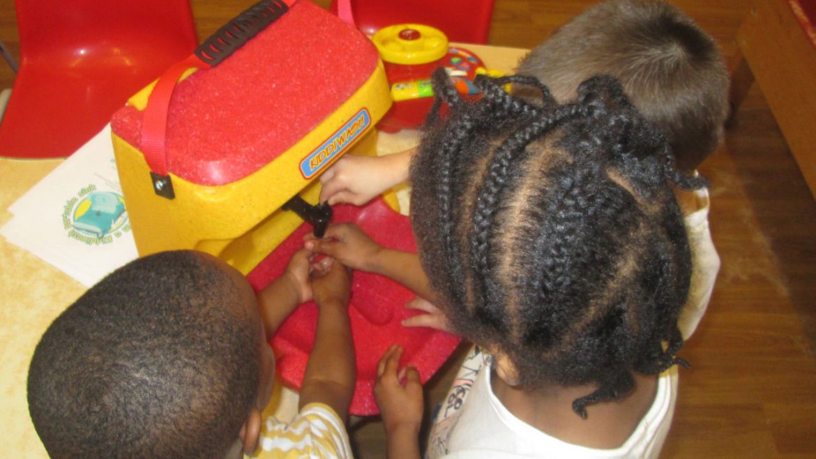 Children learning about handwashing with a KiddiWash Xtra mobile sink